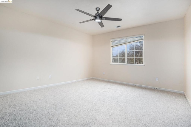 carpeted spare room with ceiling fan