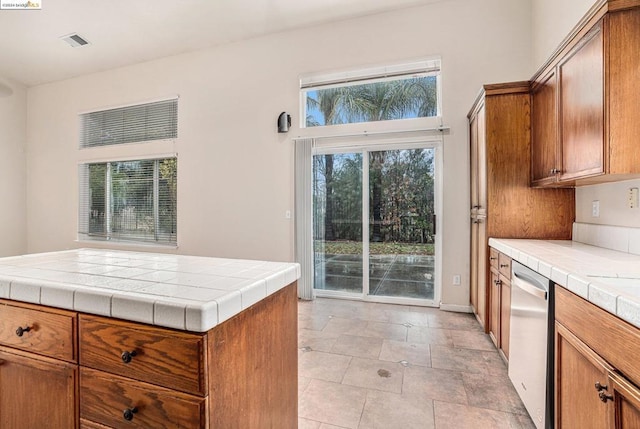 kitchen with stainless steel dishwasher and tile countertops