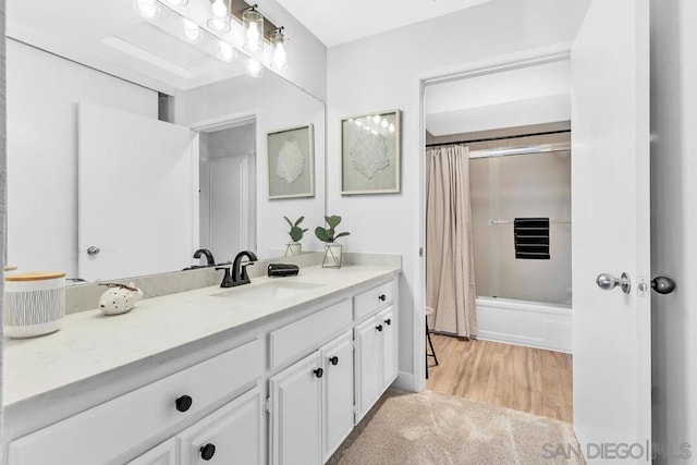 bathroom featuring shower / bath combination with curtain, wood-type flooring, and vanity