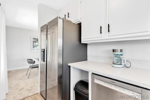 kitchen featuring light wood-type flooring, white cabinetry, and stainless steel appliances