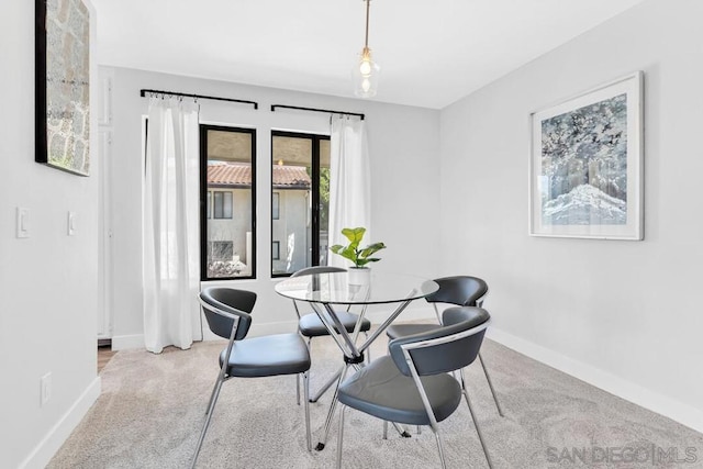 dining room with light colored carpet