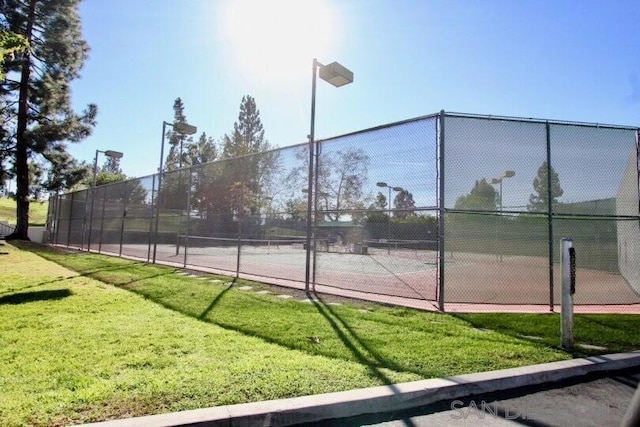 view of sport court featuring a yard