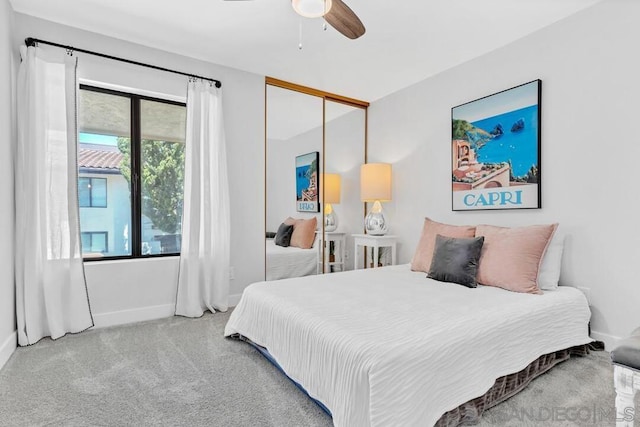 carpeted bedroom with a closet and ceiling fan