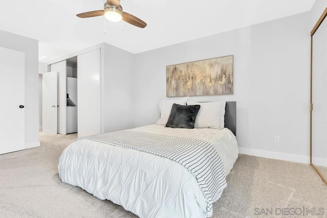 bedroom featuring ceiling fan, a closet, and light carpet