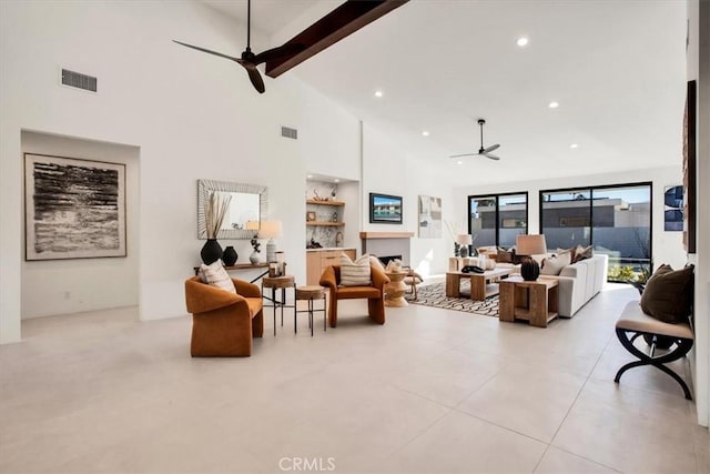 living room featuring beam ceiling and high vaulted ceiling