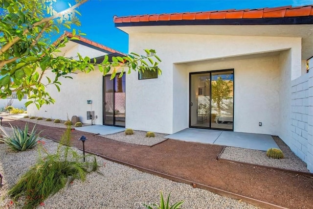 doorway to property with a patio