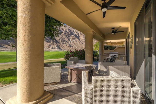 view of patio featuring ceiling fan and exterior kitchen