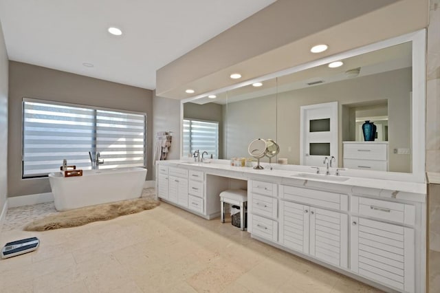 bathroom featuring a bathing tub and vanity