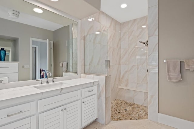 bathroom featuring vanity and a tile shower