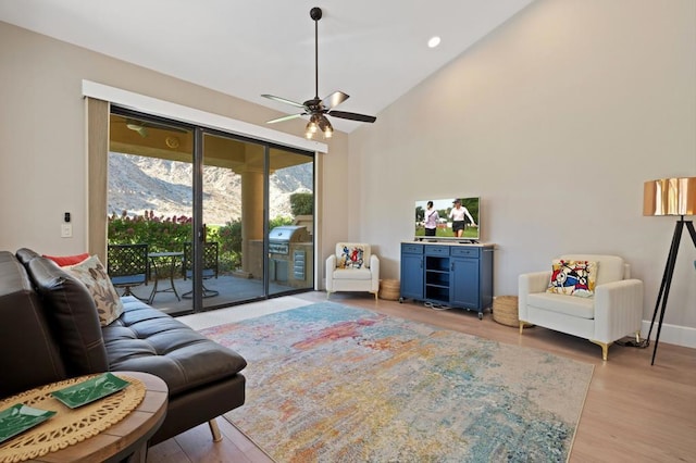 interior space featuring ceiling fan, light hardwood / wood-style floors, and high vaulted ceiling