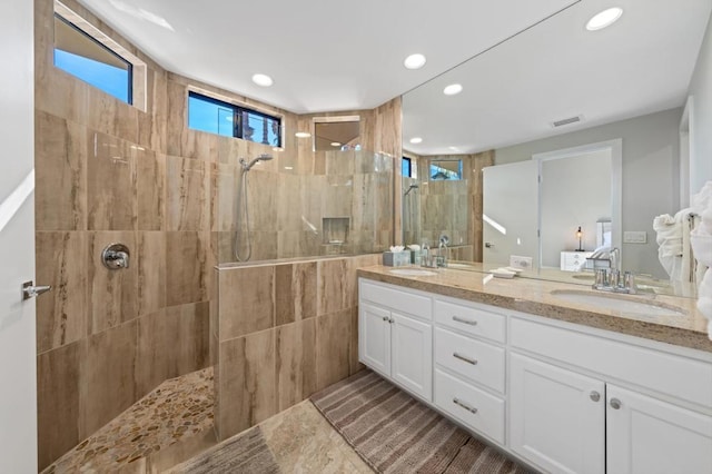 bathroom featuring vanity and tiled shower