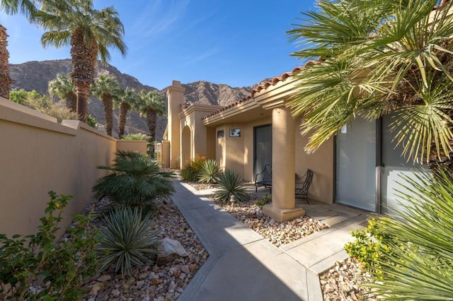 property entrance featuring a mountain view and a patio