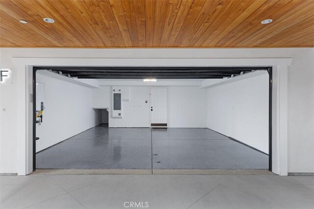 garage with electric panel and wood ceiling