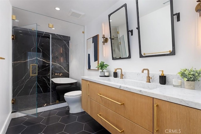 bathroom with tile patterned floors, vanity, an enclosed shower, and toilet