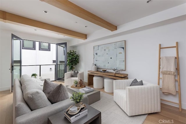 living room with beamed ceiling and light hardwood / wood-style floors