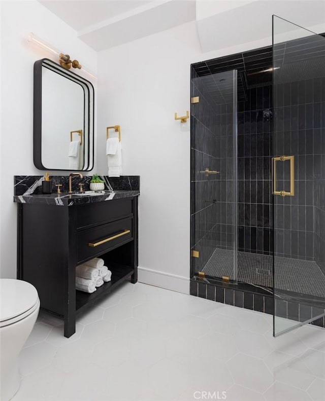 bathroom featuring toilet, vanity, tile patterned floors, and walk in shower