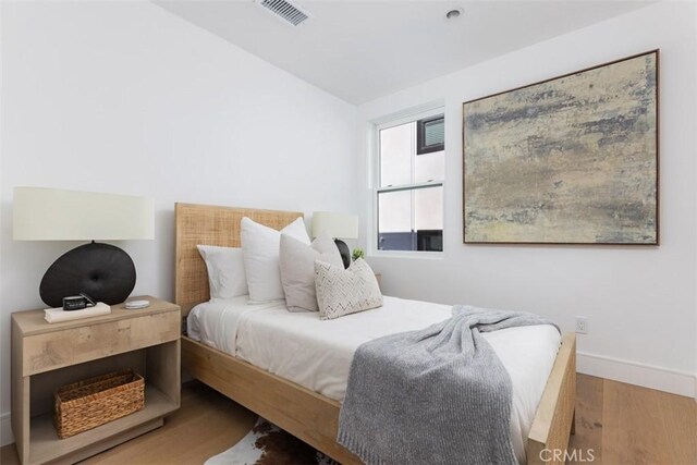 bedroom with wood-type flooring