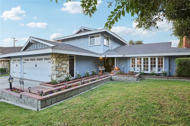 view of front of property with a front yard and a garage