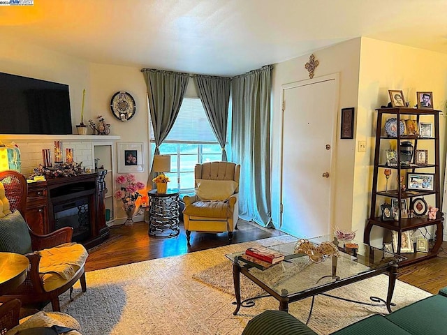 living room featuring dark hardwood / wood-style flooring and a fireplace