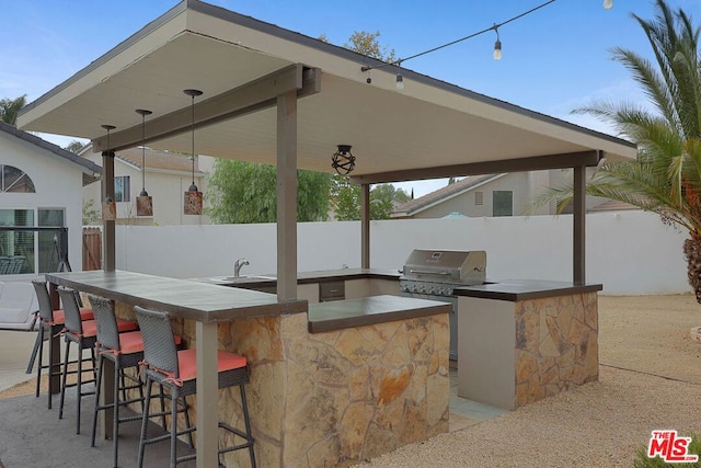 view of patio featuring area for grilling and a wet bar