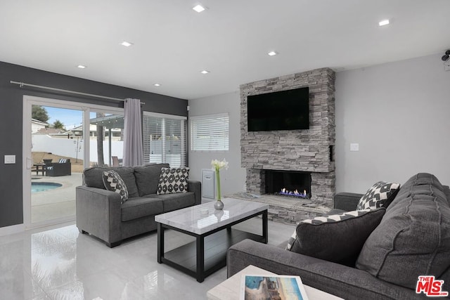 living room featuring a stone fireplace