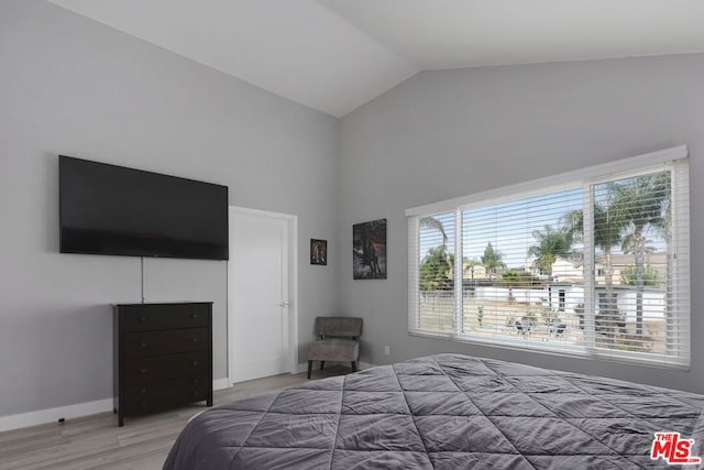 bedroom with wood-type flooring and lofted ceiling