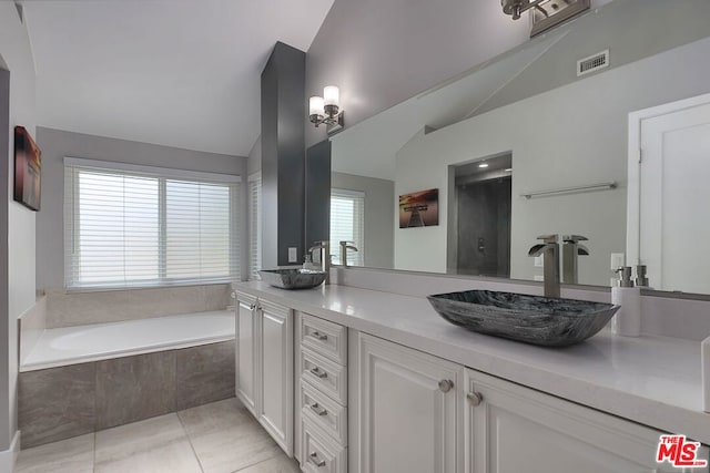 bathroom with plenty of natural light, vanity, and vaulted ceiling