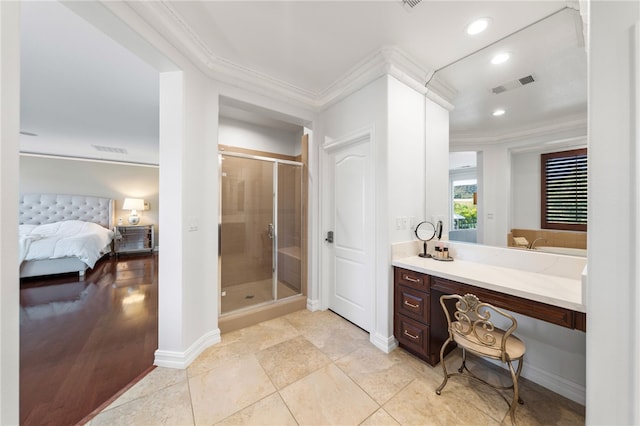 bathroom featuring tile patterned floors, vanity, an enclosed shower, and crown molding