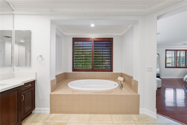 bathroom with crown molding, tile patterned flooring, vanity, and a relaxing tiled tub