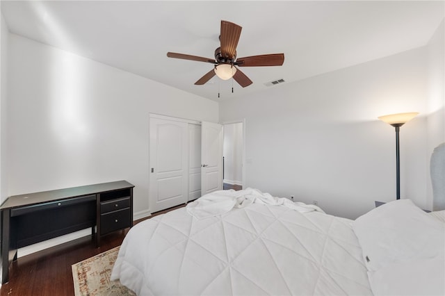 bedroom with ceiling fan, a closet, and dark wood-type flooring