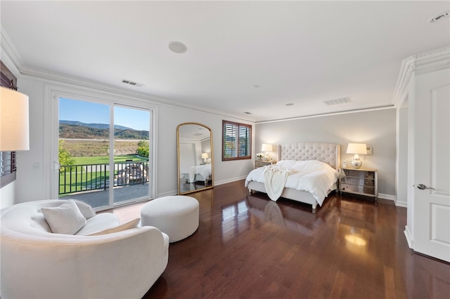 bedroom with a mountain view, dark hardwood / wood-style flooring, access to outside, and crown molding