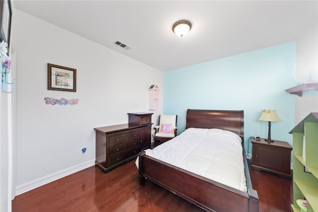 bedroom with dark wood-type flooring