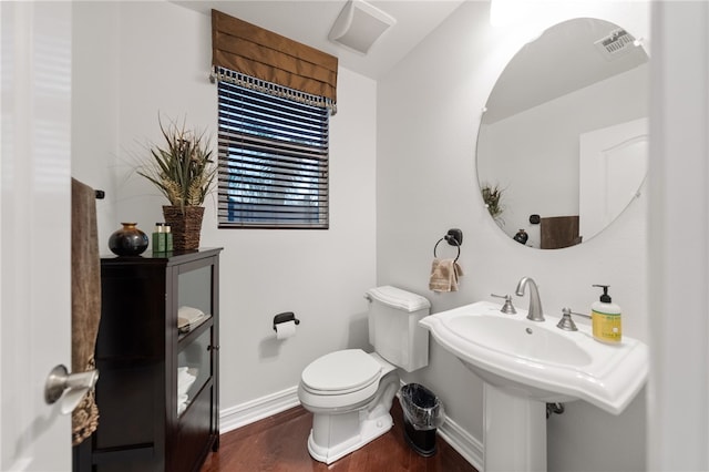 bathroom with hardwood / wood-style floors and toilet