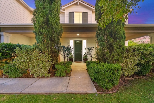 exterior entry at dusk with a porch