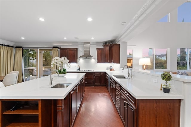 kitchen featuring plenty of natural light, wall chimney exhaust hood, and sink