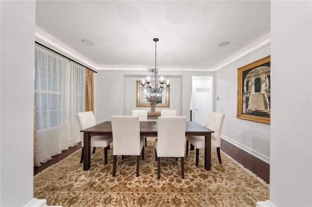 dining area with hardwood / wood-style floors and a notable chandelier