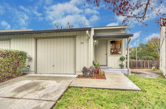 entrance to property with a yard and a garage