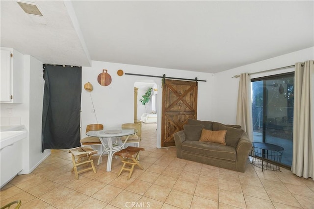 tiled living room featuring a barn door