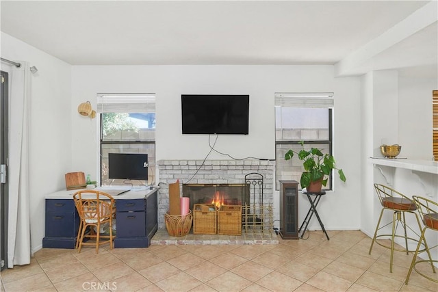 living room with a fireplace and light tile patterned floors