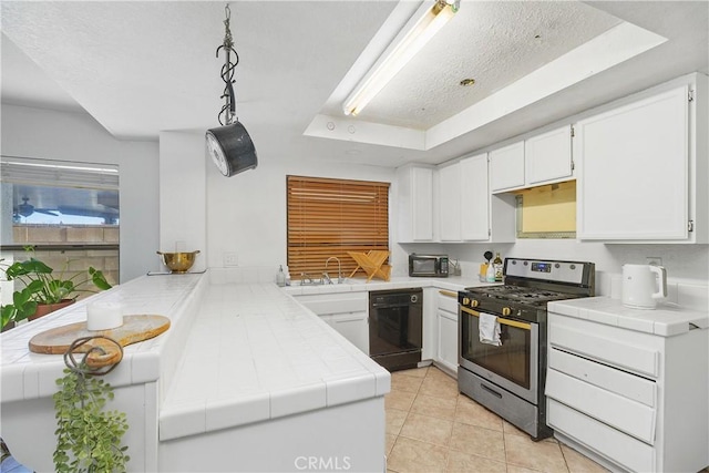 kitchen featuring dishwasher, white cabinets, gas range, a tray ceiling, and kitchen peninsula