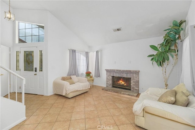 living room featuring light tile patterned flooring, a fireplace, and high vaulted ceiling