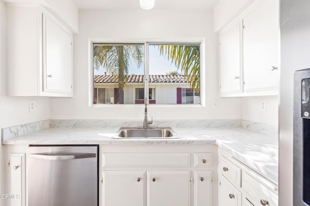 kitchen with stainless steel dishwasher and white cabinets