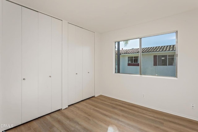 unfurnished bedroom with light hardwood / wood-style flooring