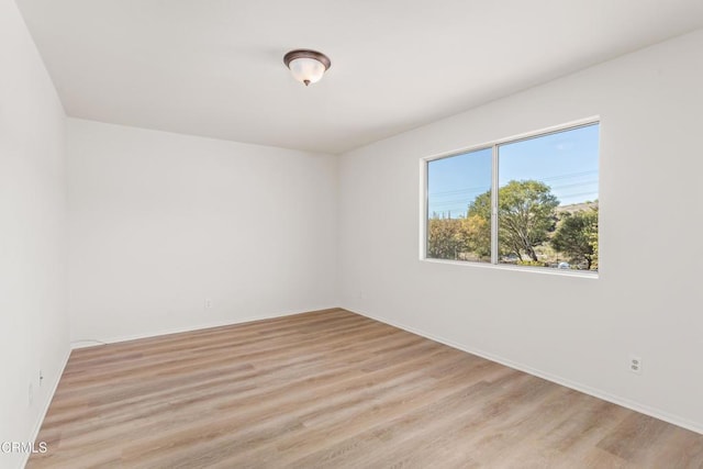 spare room with light hardwood / wood-style flooring