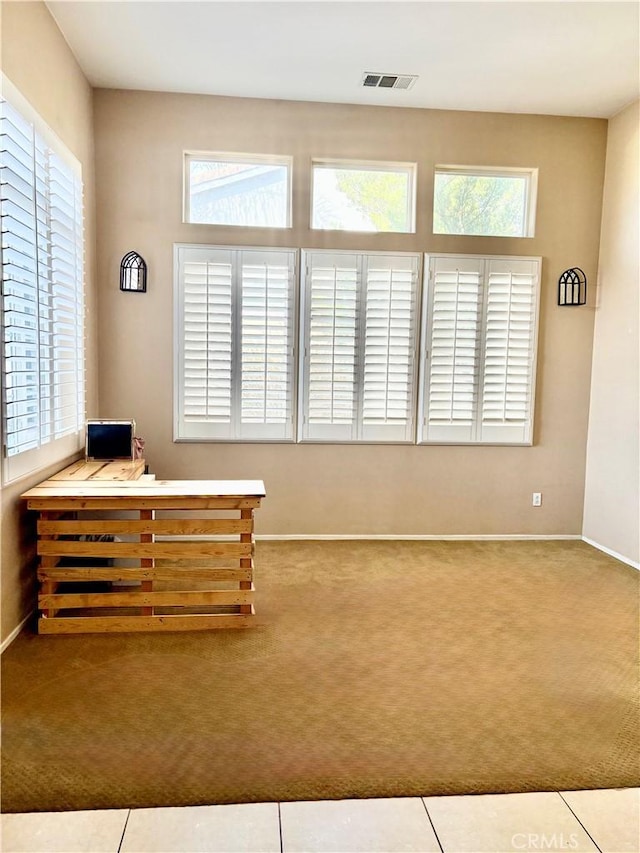 carpeted home office with visible vents and baseboards