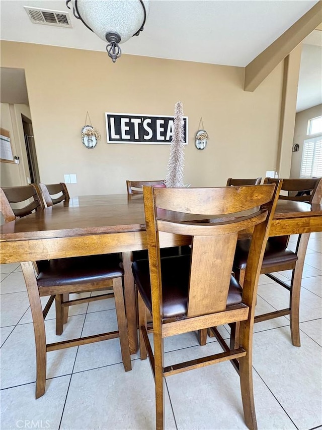 dining area featuring light tile patterned flooring and visible vents