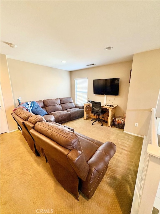 living room featuring carpet flooring, baseboards, and visible vents