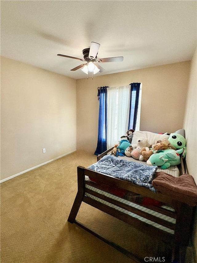 bedroom featuring carpet flooring, baseboards, and ceiling fan