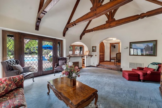 carpeted living room featuring beam ceiling, french doors, and high vaulted ceiling