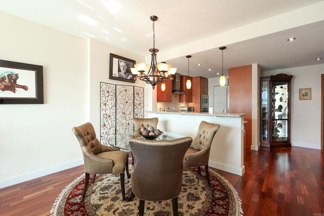 dining room with a notable chandelier and dark hardwood / wood-style flooring